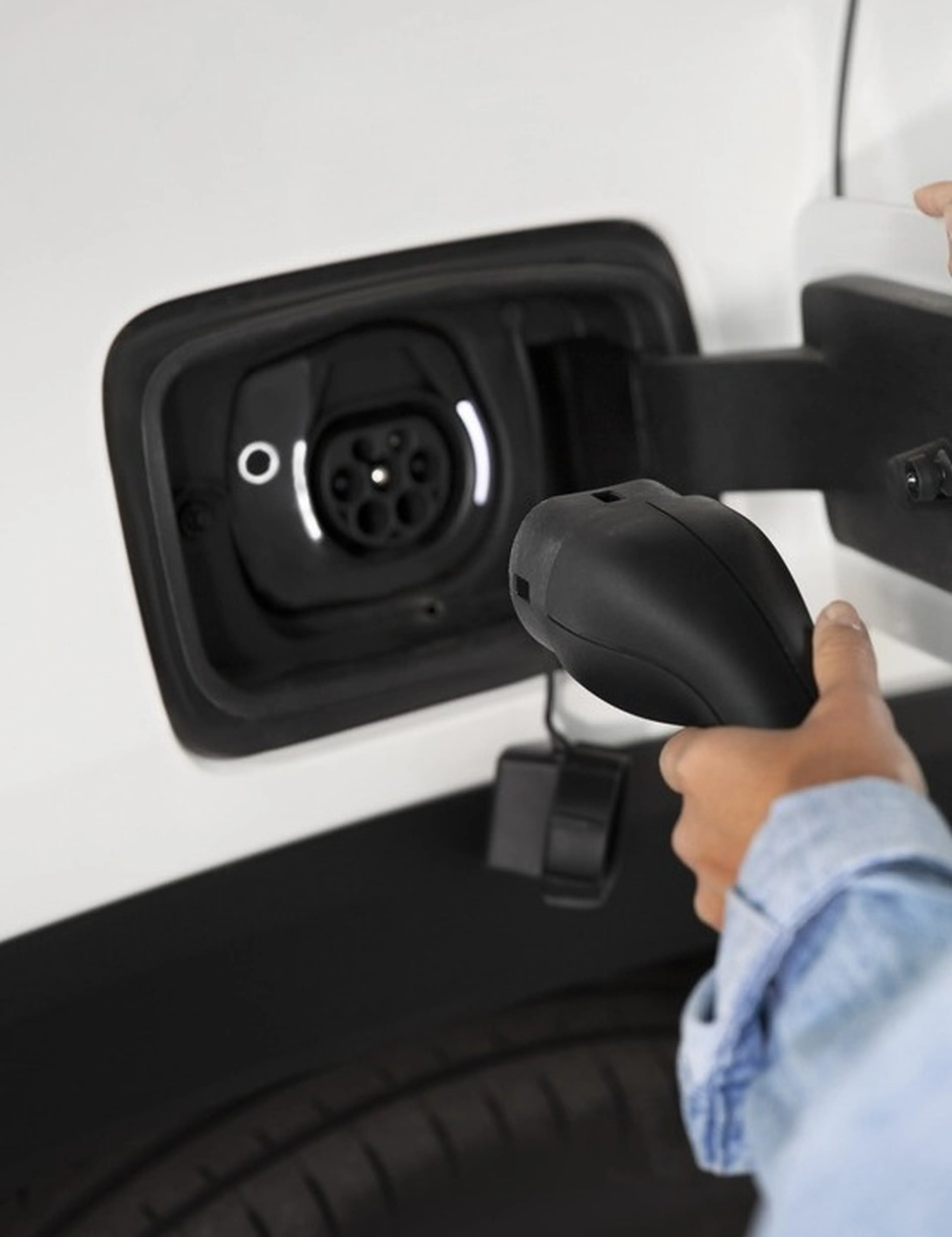 Frau läd ein E-Auto